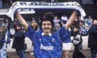 St Johnstone great Steve Maskrey in the Bonar shirt and holding a Saints scarf above his head after winning promotion to the Scottish Premier Division.