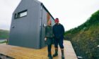 A man and a woman stand close together in front of their home which featured on Scotland's Home of the Year